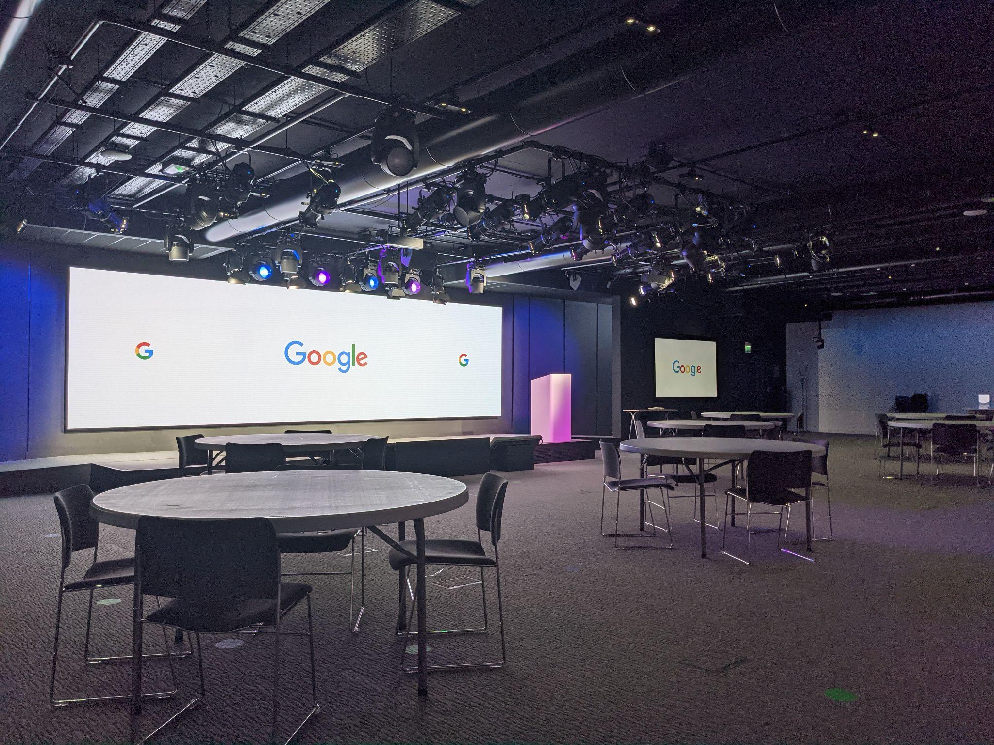 Bastille Auditorium in cabaret configuration, with round tables and a Google-logo LED backdrop.
